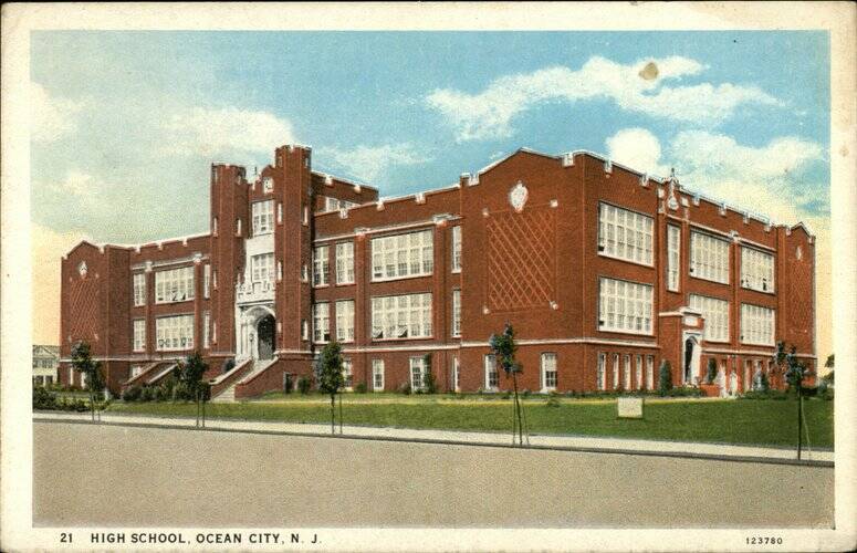 Historic photograph of Ocean City High School in New Jersey, showing its red-brick exterior, large windows, and central entrance. No Idea who was on the Ocean City School Board